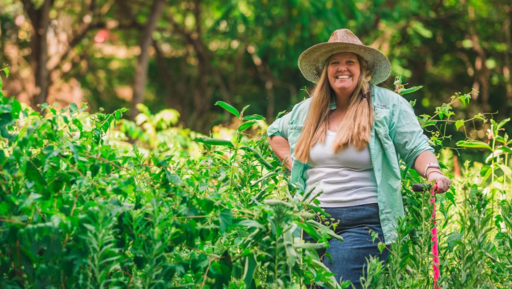 Dr. Sally Koerner smiles in a field.